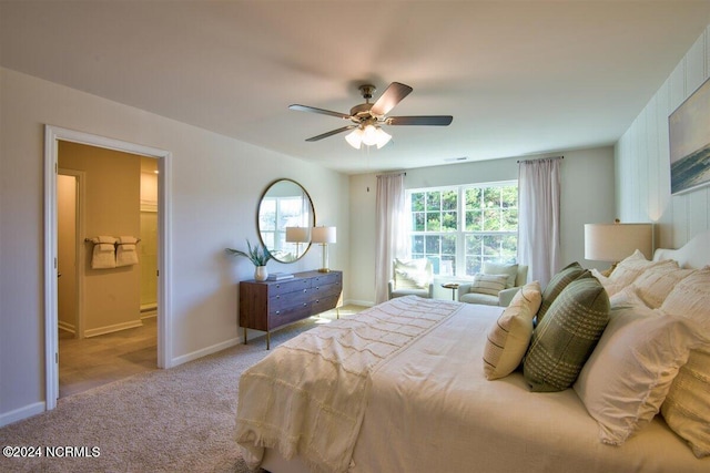 carpeted bedroom with ceiling fan, ensuite bath, and multiple windows