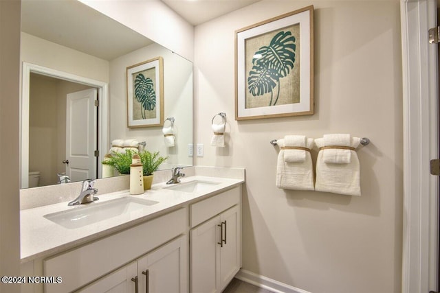 bathroom with toilet and vanity