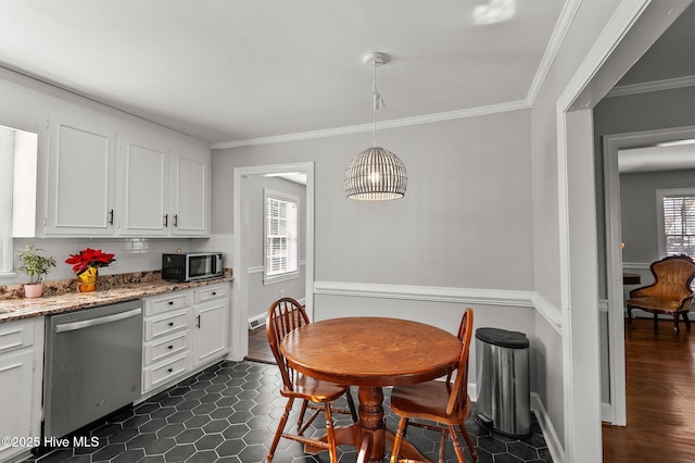 tiled dining space featuring a wealth of natural light and crown molding