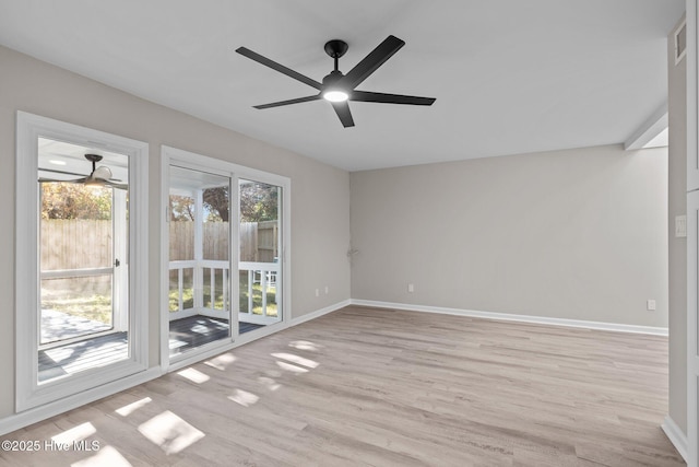 spare room with light wood-type flooring and ceiling fan