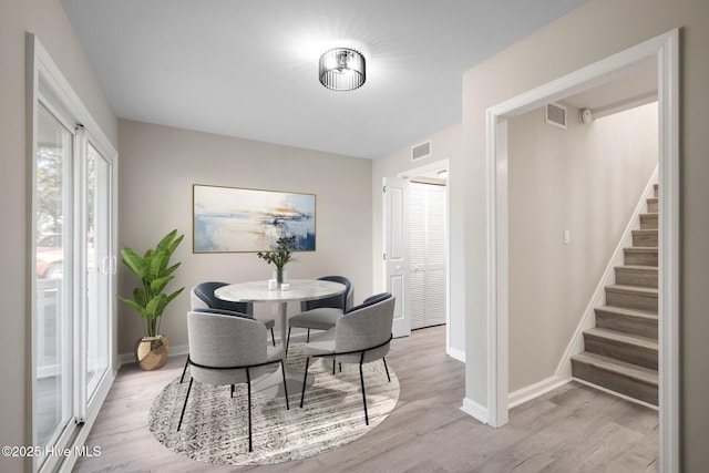 dining area with light hardwood / wood-style floors