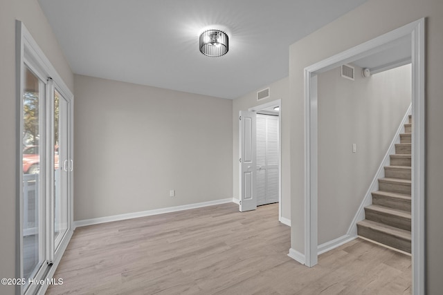 unfurnished room with light wood-type flooring