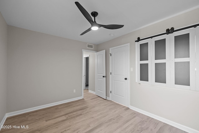 unfurnished bedroom featuring ceiling fan and light hardwood / wood-style flooring