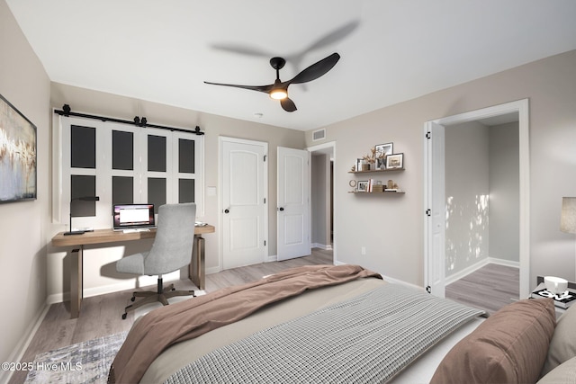 bedroom with wood-type flooring and ceiling fan