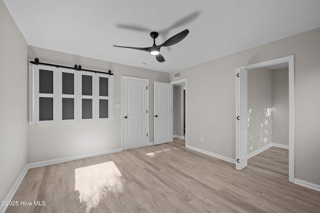 unfurnished bedroom with ceiling fan and light hardwood / wood-style flooring