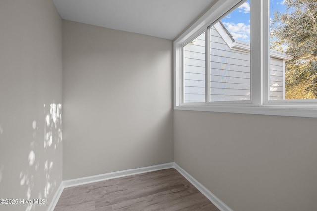 empty room with hardwood / wood-style floors