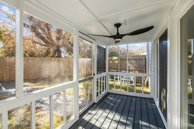 unfurnished sunroom with ceiling fan