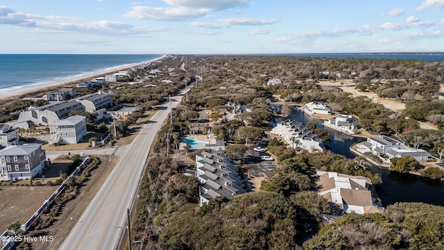 bird's eye view featuring a water view and a beach view