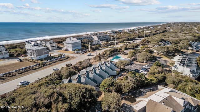 birds eye view of property featuring a water view and a beach view