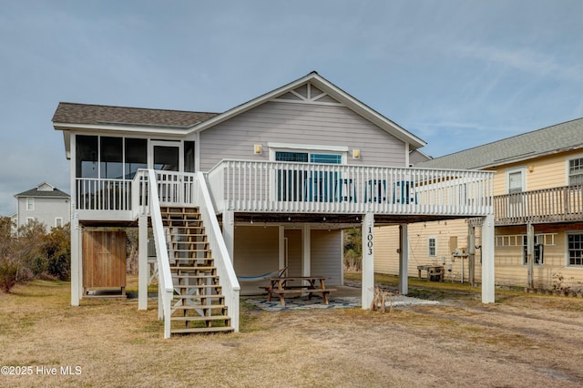 back of house with a wooden deck and a sunroom