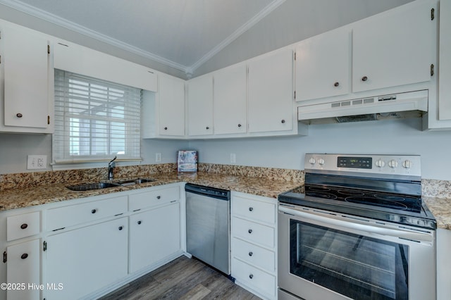 kitchen with lofted ceiling, crown molding, stainless steel appliances, light stone counters, and white cabinets