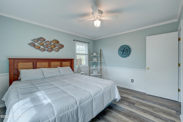 bedroom featuring hardwood / wood-style floors, ornamental molding, and ceiling fan