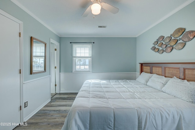 bedroom featuring crown molding, wood-type flooring, and ceiling fan