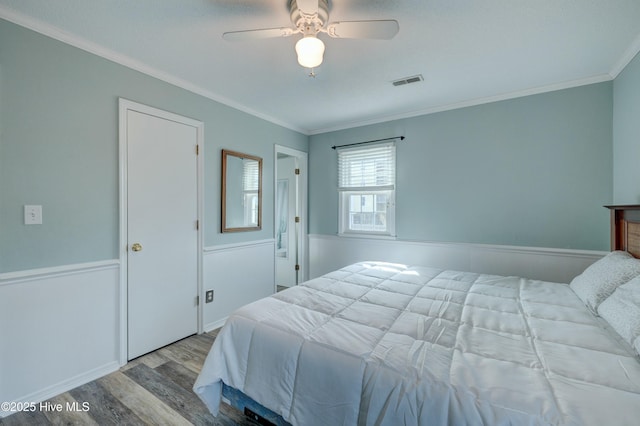 bedroom featuring crown molding, ceiling fan, and light hardwood / wood-style flooring