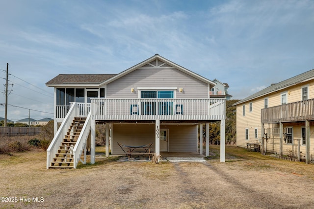 view of front of house featuring a wooden deck and a sunroom