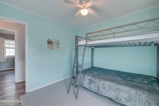 bedroom featuring hardwood / wood-style flooring, ornamental molding, and ceiling fan