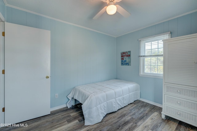 bedroom with hardwood / wood-style floors, ornamental molding, and ceiling fan