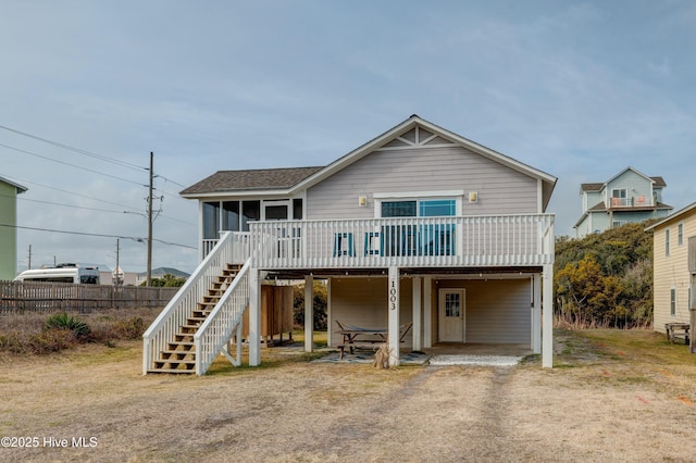 view of front facade with a sunroom and a deck