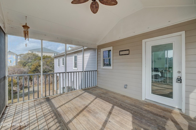 unfurnished sunroom featuring ceiling fan and vaulted ceiling