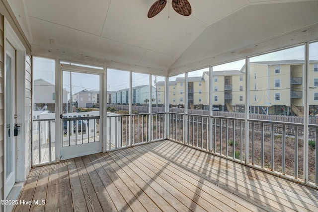 unfurnished sunroom with lofted ceiling, a wealth of natural light, and ceiling fan