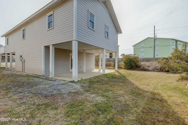 back of property with a patio and a lawn