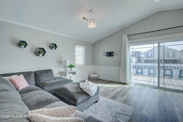 living room featuring crown molding, lofted ceiling, and wood-type flooring