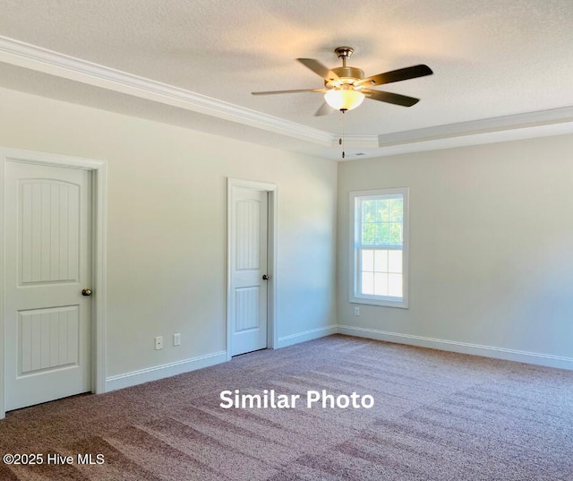 carpeted empty room with ceiling fan, a textured ceiling, and ornamental molding