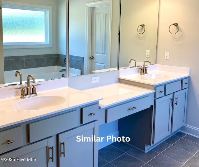 bathroom featuring a tub to relax in, vanity, and tile patterned flooring