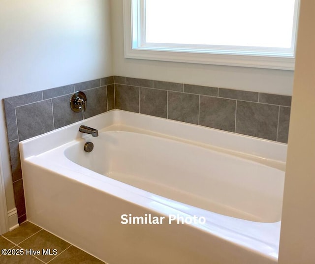 bathroom featuring a washtub and tile patterned flooring