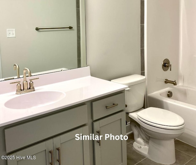 full bathroom featuring tile patterned floors,  shower combination, toilet, and vanity