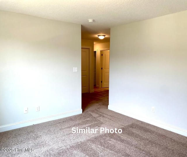 spare room with carpet floors and a textured ceiling