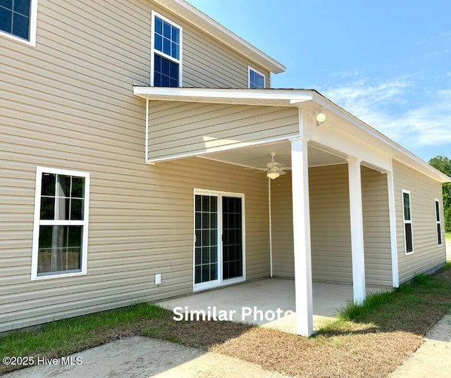 rear view of house featuring ceiling fan and a patio