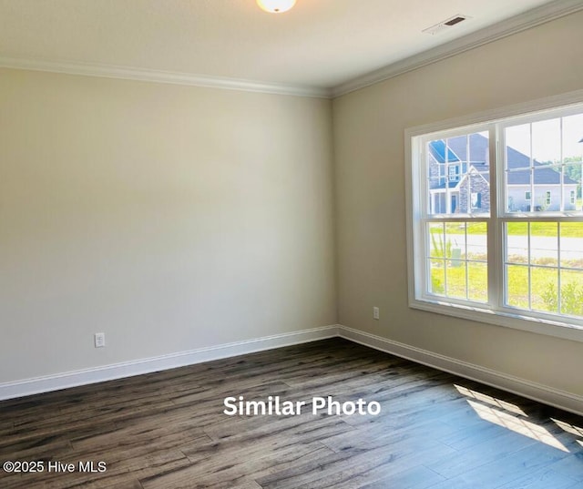 unfurnished room featuring dark wood-type flooring and crown molding