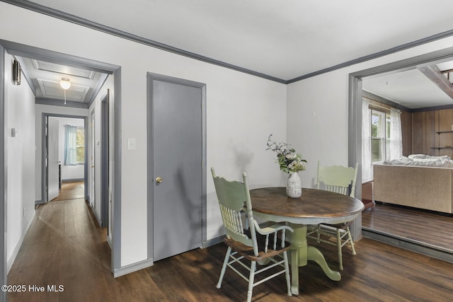 dining space with dark wood-type flooring and ornamental molding