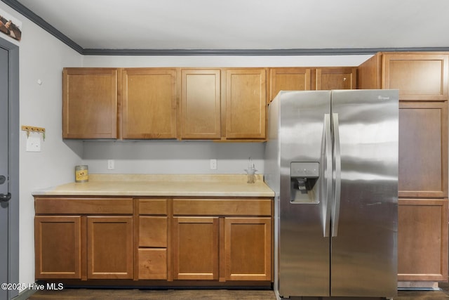 kitchen featuring crown molding and stainless steel fridge with ice dispenser