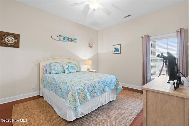 bedroom with visible vents, ceiling fan, baseboards, and wood finished floors