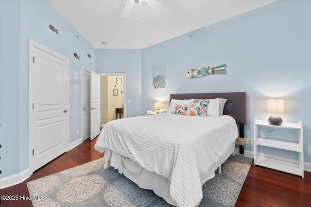 bedroom featuring dark wood-style floors, ceiling fan, and baseboards