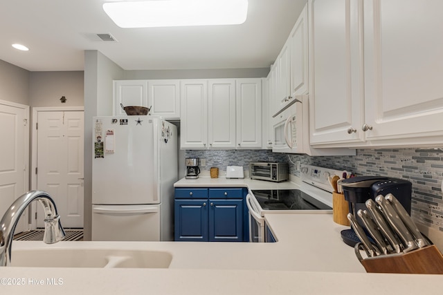 kitchen with decorative backsplash, blue cabinetry, white appliances, white cabinets, and sink