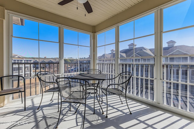 sunroom / solarium featuring ceiling fan