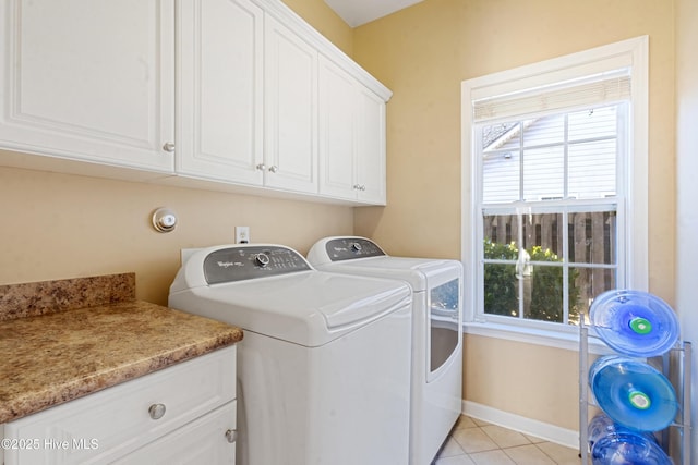 laundry area with cabinets, light tile patterned flooring, and washer and dryer