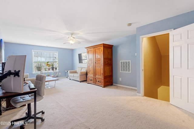 carpeted home office with ceiling fan