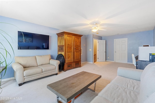 carpeted living room featuring ceiling fan