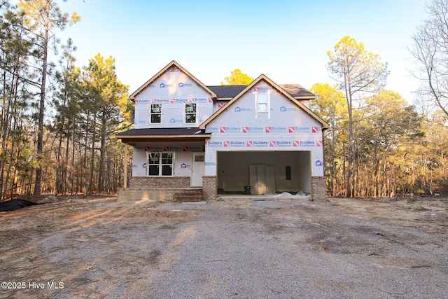 view of front facade featuring a garage, brick siding, and driveway