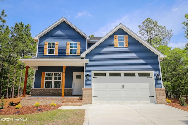 view of front of home featuring brick siding, a front lawn, driveway, and an attached garage