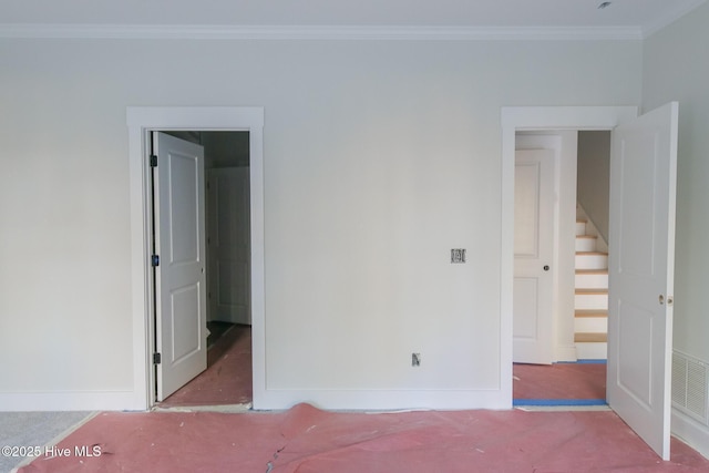 unfurnished bedroom with ornamental molding, visible vents, and baseboards