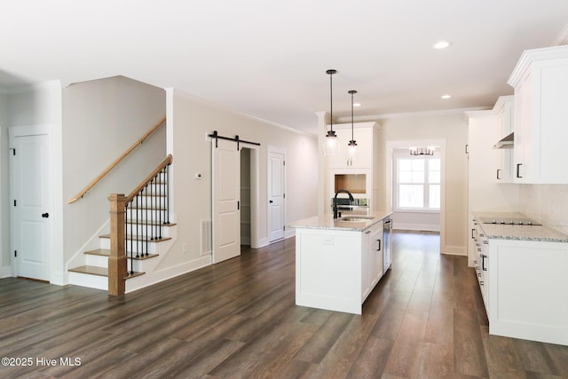 laundry room with a barn door, laundry area, ornamental molding, electric dryer hookup, and washer hookup