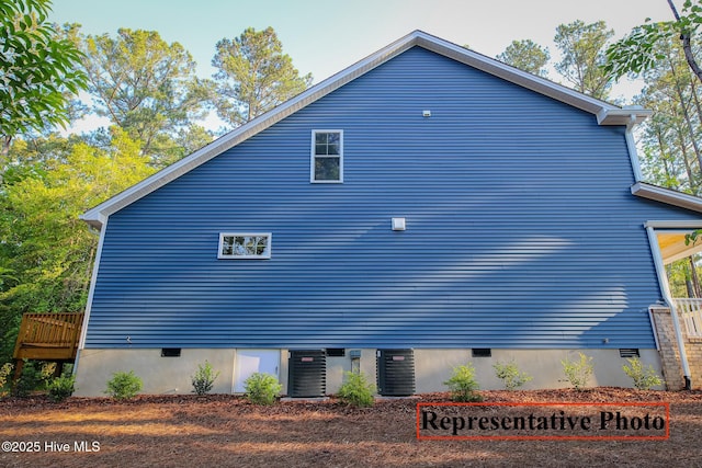 view of home's exterior featuring cooling unit and crawl space