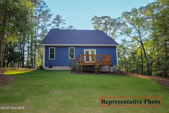 rear view of property with a shingled roof, crawl space, a lawn, and a wooden deck