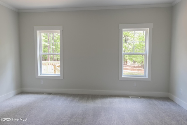 empty room with light carpet, a ceiling fan, visible vents, and a healthy amount of sunlight
