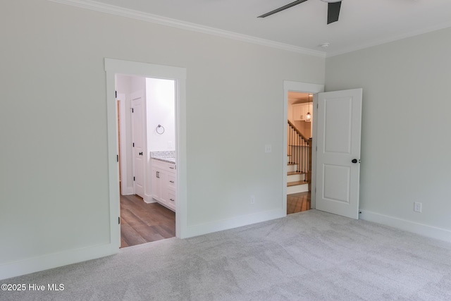 carpeted empty room with baseboards and ceiling fan